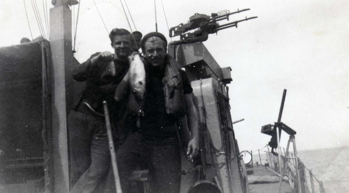 Bonafacio Straits - self and Hughie with fish brought to surface by exploding mine.jpg